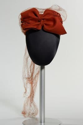 Orange pillbox with two bows and veil