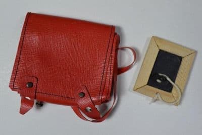 Doll's satchel, red PVC, for Bleuette, 1950s

Doll's writing slate, wooden frame with attached rubber